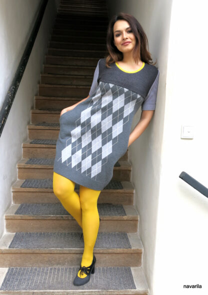 IMG 9935 scaled KAIRA I.- dress with a checkered pattern Original recycled knitted dress with a checkered retro pattern, with short sleeves and a yellow neckline. One unique original, with sewn-on pink pockets in the side seam! Material - blended yarn from an Italian manufacturer consisting of merino wool and polyester. All models are already pre-washed, maintenance very practical - hand wash or washing machine for a delicate program up to 30 degrees. The only size available - M / L Original recycled knitted dress with a checkered retro pattern, with short sleeves and a yellow neckline. One unique original, with sewn-on pink pockets in the side seam! Material - blended yarn from an Italian manufacturer consisting of merino wool and polyester. All models are already pre-washed, maintenance very practical - hand wash or washing machine for a delicate program up to 30 degrees. The only size available - M / L