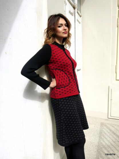 1024574134 4 3150275096 1 NEMO IV.- knitted jacket with black sleeves The red patterned jacket was created from the remaining parts from the previous production, which was waiting for a new life. Knitted with a jacquard pattern from cotton yarn, it guarantees the softest texture to all that is wool. Black sleeves, collar and placket, button fastening. Slightly tapered at the waist. This model is already sold, we can create a similar one to order within 10 days. The models from recycled parts can never be exactly the same! Each model is original. Can be completed with a beautiful original dress of the same pattern or a skirt. Yarn composition - 50% cotton + 50% polyester. All our models are already pre-washed, maintenance is very practical - machine washes on a delicate program.   The red patterned jacket was created from the remaining parts from the previous production, which was waiting for a new life. Knitted with a jacquard pattern from cotton yarn, it guarantees the softest texture to all that is wool. Black sleeves, collar and placket, button fastening. Slightly tapered at the waist. This model is already sold, we can create a similar one to order within 10 days. The models from recycled parts can never be exactly the same! Each model is original. Can be completed with a beautiful original dress of the same pattern or a skirt. Yarn composition - 50% cotton + 50% polyester. All our models are already pre-washed, maintenance is very practical - machine washes on a delicate program.  